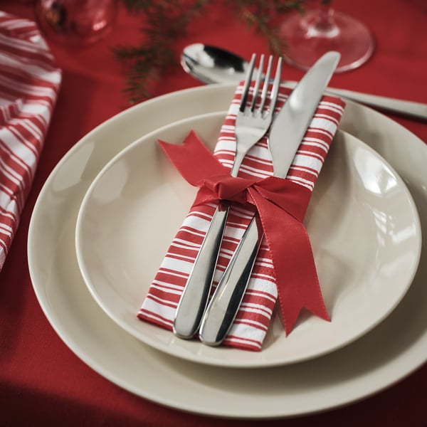 VINTERFINT red and white striped napkin, wrapped with silverware, on white plates, large.