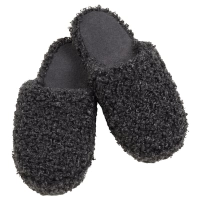 Pair of black, textured, cozy slippers with grippy soles, perfect for comfort.