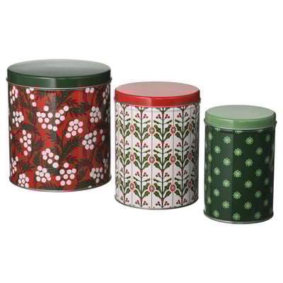 Three decorative holiday-themed tin containers in red, green, and white. Round shape with festive patterns. Perfect for storing treats.