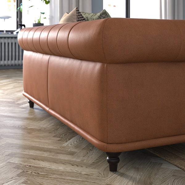 Brown leather VISKAFORS sofa, rounded design, wooden legs.
