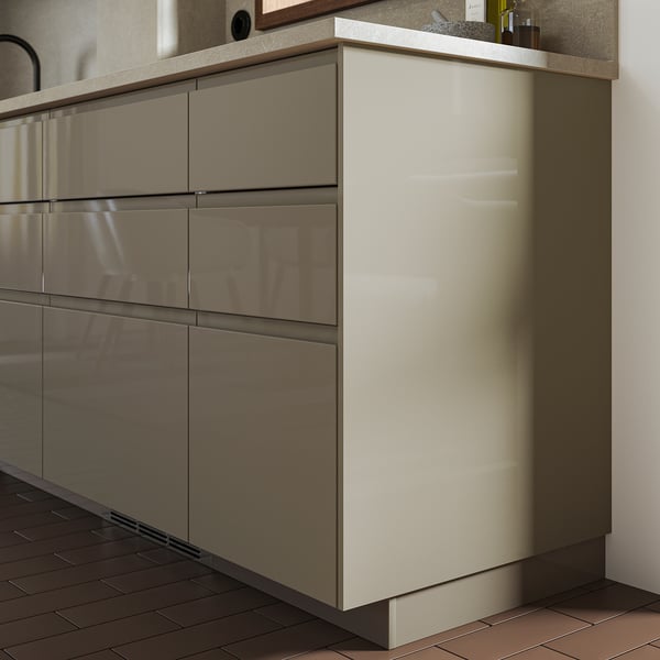 VOXTORP cabinet in light beige with glossy finish and plastic edging, sleek and modern design.