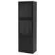 Opción: Armario BESTÅ negro: alto, delgado, puertas de cristal, cajones de madera en la parte inferior, forma rectangular.
