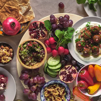 Frutas variadas, nueces y platos en tazones de madera, metal y vidrio blanda para servir, que muestran su capacidad de apilamiento y uso versátil.
