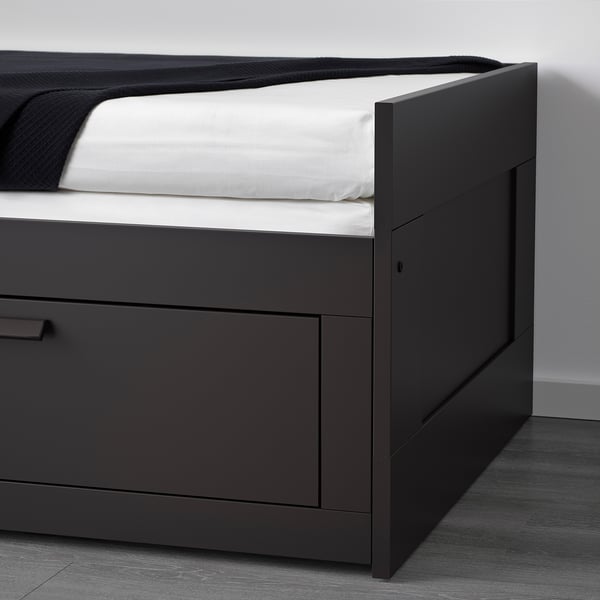 Sofá-cama convertible negro con gran espacio de almacenamiento, se muestra parcialmente hecho.