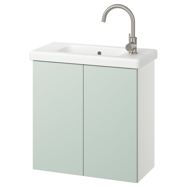 Moderno mueble de baño verde claro con lavabo blanco, grifo plateado, que ofrece almacenamiento y un diseño elegante.
