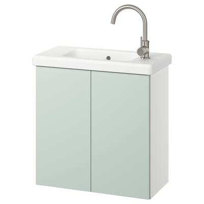 Moderno mueble de baño verde claro con lavabo blanco, grifo plateado, que ofrece almacenamiento y un diseño elegante.