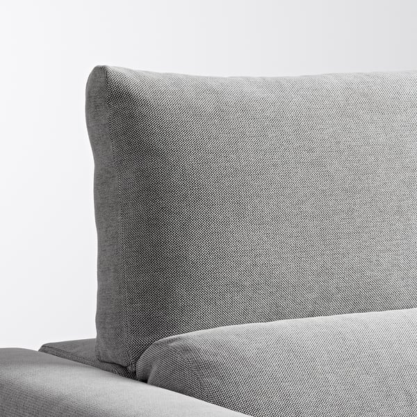 Primer plano del sofá de tela gris. Espalda alta, tejido texturizado, parece suave y de apoyo.