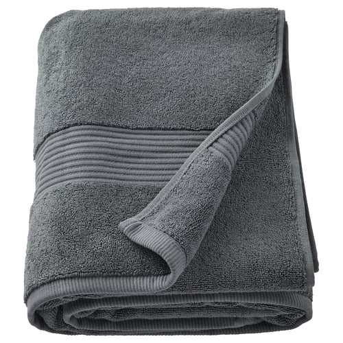 Toalla de baño fredriksjon gris oscuro doblada, 100% algodón, gruesa, con bordes acanalados.