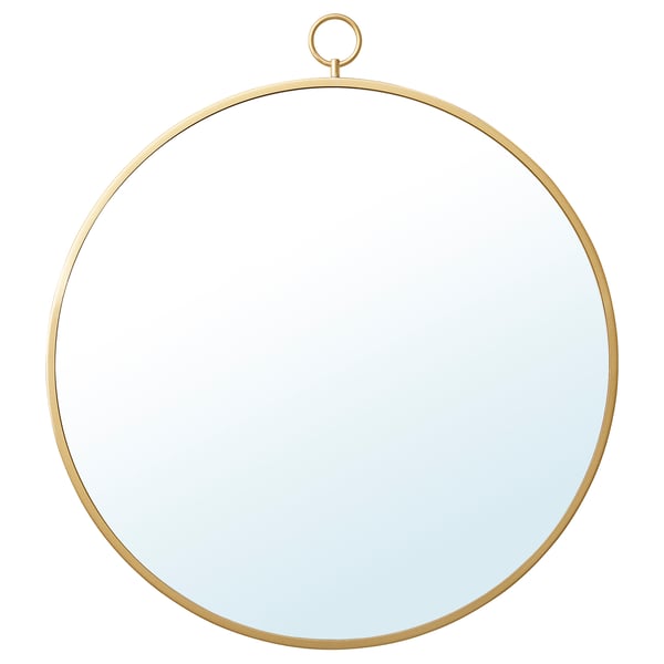 Un espejo redondo de color dorado llamado GRYTÅS con un marco de latón y un lazo para colgar. Es una pieza decorativa moderna apta para paredes o mesas.