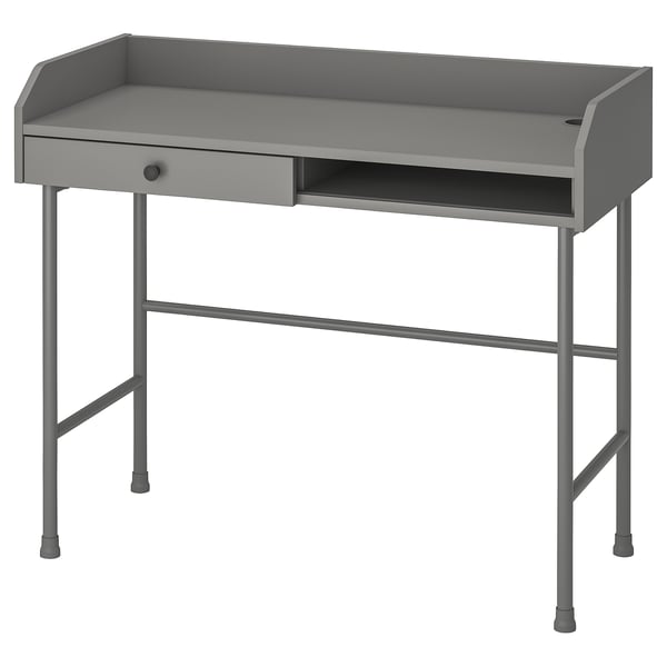 Un escritorio HAUGA gris con un diseño moderno. Hecho de metal y madera, es una mesa, un cajón y un compartimento abierto, que ofrece espacio de trabajo y almacenamiento.