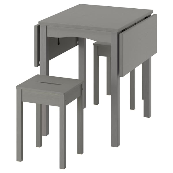 Mesa de hojas caídas gris HAUGA con dos taburetes. Diseño que ahorra espacio, madera maciza, rectangular, estilo simple.