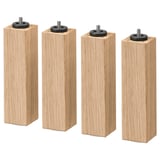 Cuatro patas cuadradas de madera de roble marrón claro con pernos de metal negro en la parte superior, alineadas una al lado de la otra.