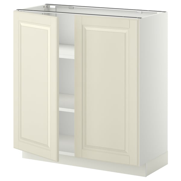 Mueble de cocina blanco roto, serie METOD, forma rectangular, dos puertas, bordes biselados, color crema.