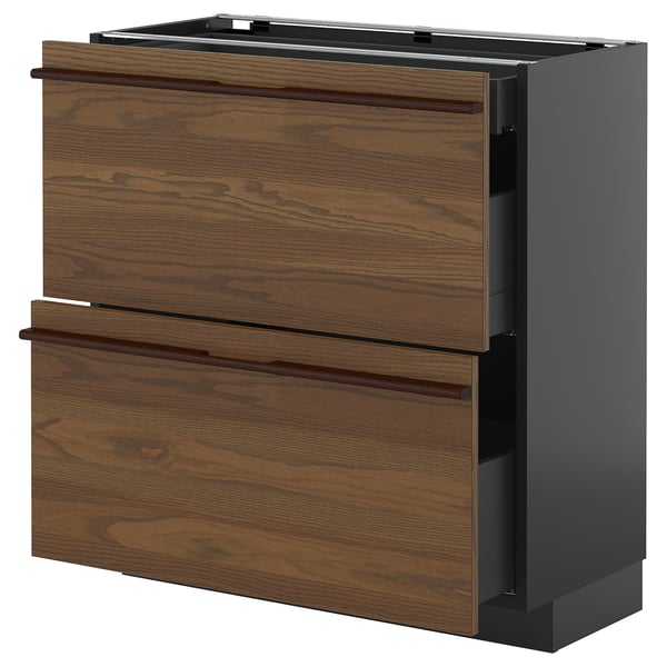 Un mueble de cocina METOD de ikea en color marrón oscuro con tiradores de madera, con dos cajones y un armario.