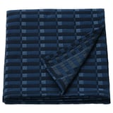 Manta SKOGSKOVALL de algodón a cuadros azules doblada, forma cuadrada, tonos grises oscuros y claros.