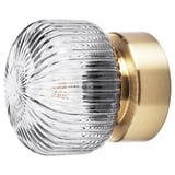 Lámpara SOLKLINT con pantalla de cristal gris rayado y base de latón brillante, que combina un diseño moderno con una suave iluminación ambiental.