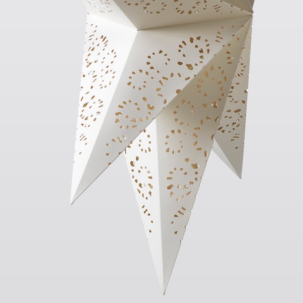 Lámpara de papel en forma de estrella con intrincados recortes que proyectan una luz cálida. Materiales de alta calidad: cartón, policarbonato, acero inoxidable.