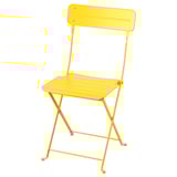 Silla plegable de color amarillo brillante, estructura de acero, asiento y respaldo planos, perfecta para espacios pequeños.