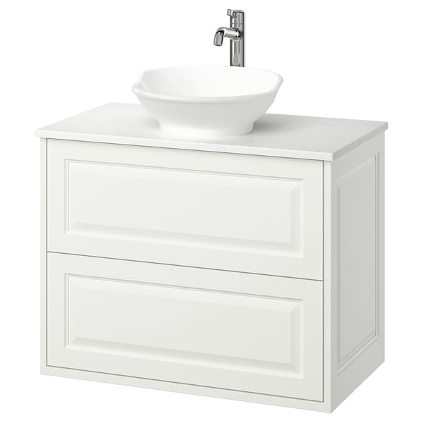 Moderno tocador de baño blanco de pared con lavabo redondeado y grifería cromada.