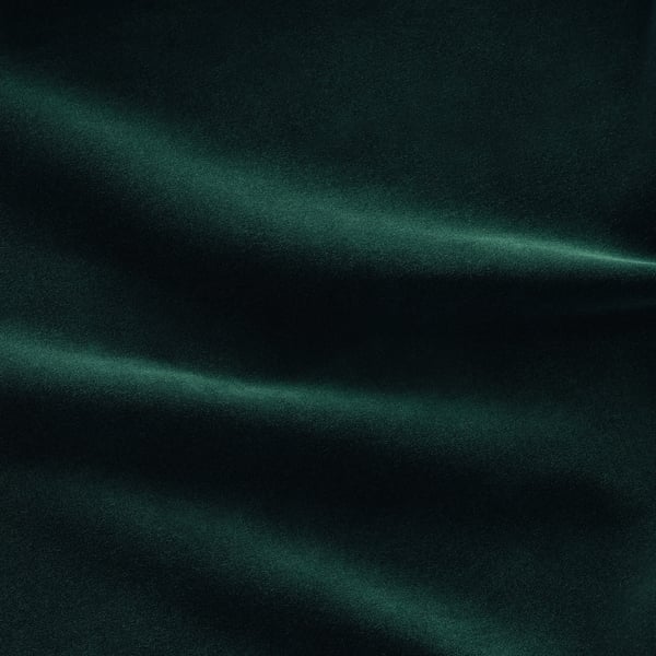 Texturas suaves de terciopelo verde con un brillo elegante, que muestran un material de sofá de primera calidad.