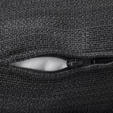 Cremallera negra en sofá estructurado de tela tejida, que ofrece durabilidad y comodidad.