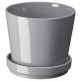 gres gris eta zurizko lorazaina, platertxoarekin, diseinu sinple eta biribilduarekin.