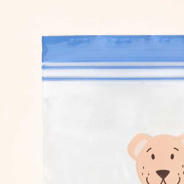 Plastikozko poltsa gardena, itxitura urdinarekin, partzialki itxia, marrazki bizidunen hartz-buruarekin. Kalitate handikoak, berrerabilgarriak eta ihes-probakoak.