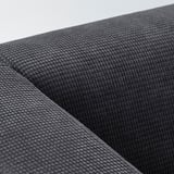 Sofa baten tapizeriaren antzeko oihal beltz baten lehen planoa, eredu akoltxatu bat ehunduta duena.