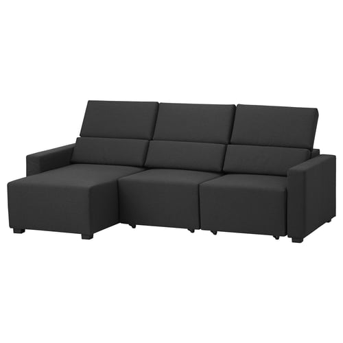 Sofa beltza, L formakoa, bizkarraldea estutzeko modukoak. Diseinu modernoa eta minimalista. Eroso akoltxatua eta egurrezko hanka sendoak.