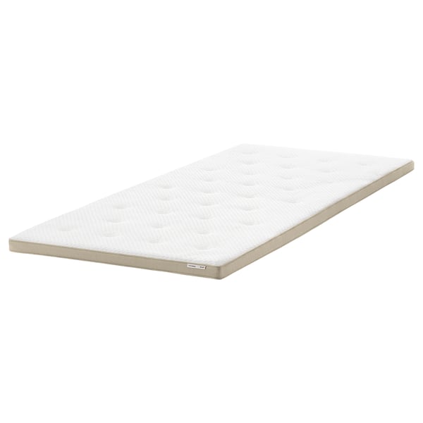Beige argiko TISTEDAL estalki bat, lihoa eta latexa bezalako material naturalekin egina, erosotasuna eta transpirabilitatea eskaintzeko diseinatua.