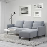 Sofá seccional ANGERSBY en gris, compacto e espazoso con chaise, en moderna configuración de sala de estar.