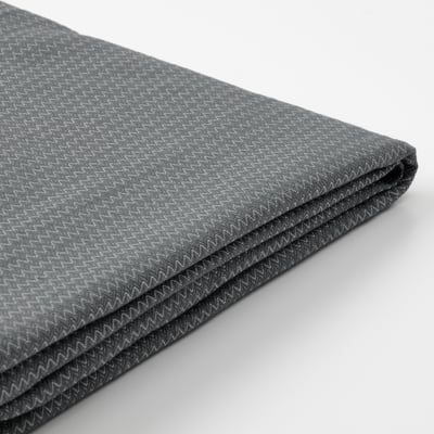 Tecido gris escuro dobrado con patrón zigzag sutil, probablemente unha cuberta lavable de alta calidade.