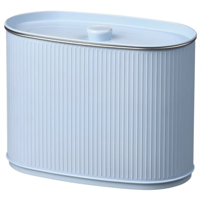 Un colector de almacenamento branco de forma ovalada cun deseño acanalado, feito de aceiro estaño e un mango na tapa.
