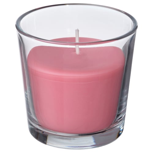 Vela perfumada rosa en vidro transparente, forma cilíndrica con bordos lisos.