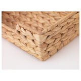 Cesta de hiacinto de auga tecida a man, que amosa trenzas intrincadas e textura natural.
