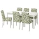 Mesa de comedor branca con 6 cadeiras, branca con cubertas con patróns de follas verdes.