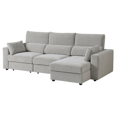 Sofá ESKILSTUNA gris con chaise longue axustable, respaldo alto e coxíns acolchados.
