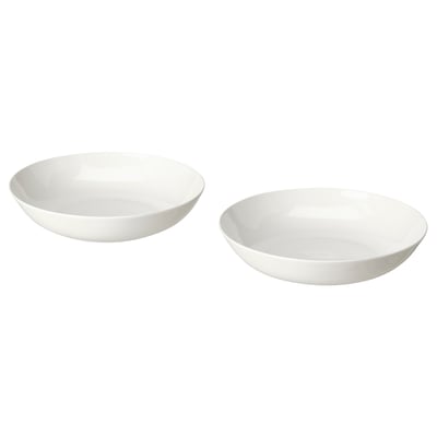 Dúas cuncas de porcelana branca, unha lixeiramente máis grande que a outra, con formas suaves e orgánicas e deseños sinxelos. Perfecto para servir ou comer.