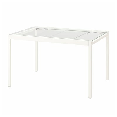 Unha mesa branca de vidro GLIVARP. O seu deseño moderno, catro patas de metal branco e unha mesa de vidro temperado transparente.