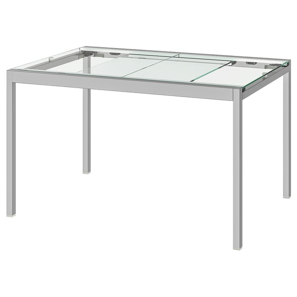 Mesa de vidro GLIVARP: elegante, rectangular, con marco cromado e tapa de vidro transparente. Deseño moderno e minimalista para pequenos espazos.