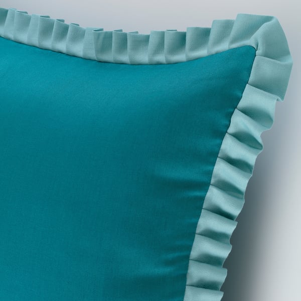 Cuberta de coxín turquesa con superficie lisa e brillante. Cremadeira oculta, material de algodón suave.
