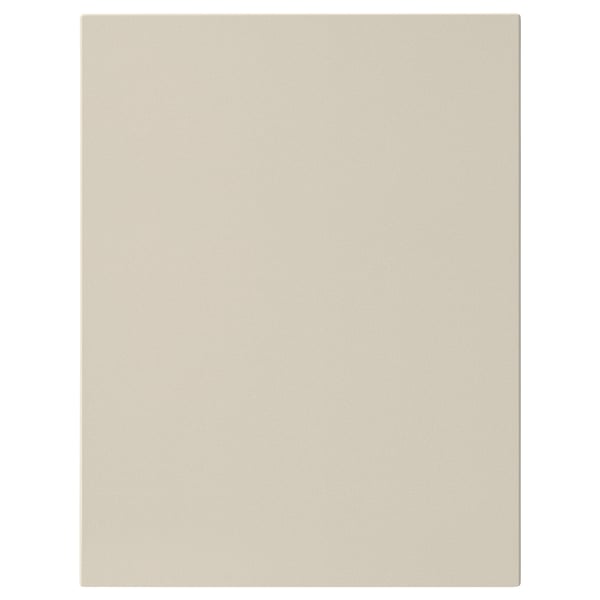 Un panel frontal beige HAVSTORP cun deseño suave, perfecto para unha cociña moderna.