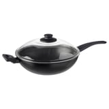 Un wok HEMLAGAD negro cunha tapa de vidro e dous mangos robustos. A súa superficie antiadherente e o seu deseño profundo convérteno ideal para cociñar sen derrames.