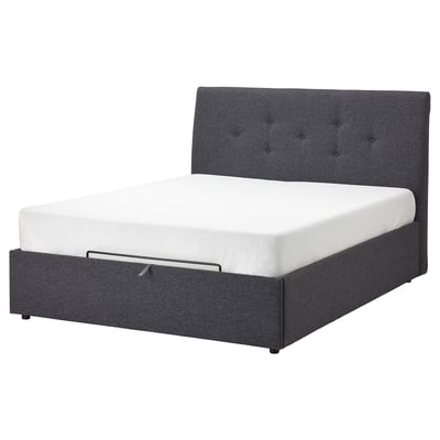 IDANÄS cama tapizada gris escuro con cabeceira tufted e colchón branco.