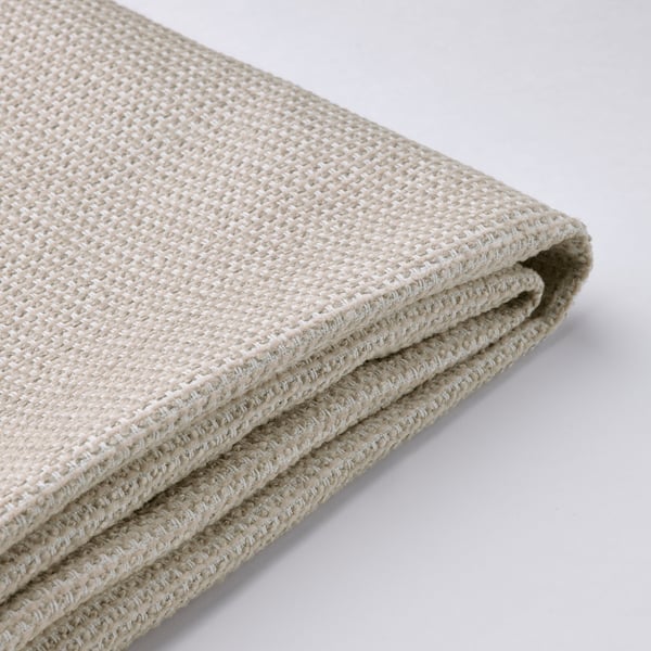 Tecido beige dobrado con patrón de tecido intrincado, textura suave, apilado ordenadamente para a exhibición.