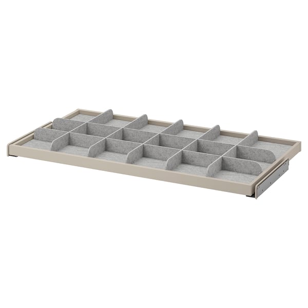 Un organizador de caixóns KOMPLEMENT branco con divisores de tecido para almacenar ordenado.
