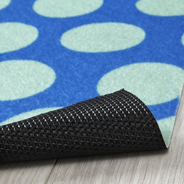 Alfombra de porta punteada azul e verde con soporte de goma negra texturizada para o agarre.