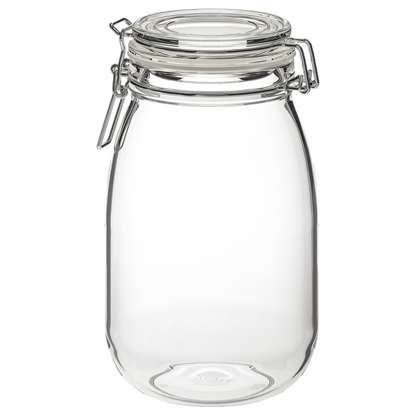 Frasco de vidro transparente con tapa de abrazadeira metálica e selo de goma, corpo redondo e deseño transparente.
