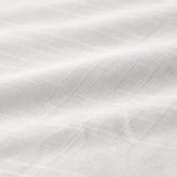 Primeiro plano de tecido suave, 100% algodón. Textura nítida, liñas bordadas horizontais. Ecolóxico e duradeiro.