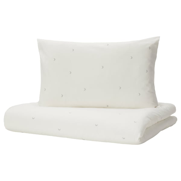 Conxunto de roupa de cama para bebés branco con deseño de lúa crecente, feito de algodón suave, de forma rectangular.